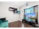 Cozy living room with hardwood floors, modern shelving, and a large flat-screen television at 13547 Roderick Dr, Huntersville, NC 28078