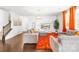 Inviting living room with hardwood floors, gray sectional, bright orange rug, and contemporary decor at 13547 Roderick Dr, Huntersville, NC 28078