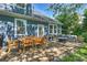 The back patio features a dining table and chairs and outdoor seating with a fire pit at 1405 Ridge Haven Rd, Waxhaw, NC 28173