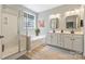 Bright bathroom featuring double vanities, a soaking tub, and a glass-enclosed shower at 1405 Ridge Haven Rd, Waxhaw, NC 28173
