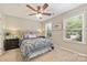 Bedroom featuring lots of light from large windows, ceiling fan, and modern decor at 1405 Ridge Haven Rd, Waxhaw, NC 28173