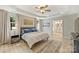 Tranquil bedroom features tray ceilings, hardwood floors, and large windows providing plenty of natural light at 1405 Ridge Haven Rd, Waxhaw, NC 28173