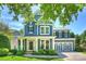 Charming blue two-story home with a manicured lawn, attached garage, and covered front porch at 1405 Ridge Haven Rd, Waxhaw, NC 28173