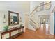Welcoming foyer with hardwood floors, a staircase, and designer accents at 1405 Ridge Haven Rd, Waxhaw, NC 28173