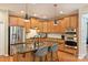 Beautiful kitchen with hardwood floors, granite countertops, stainless appliances, and a center island at 1405 Ridge Haven Rd, Waxhaw, NC 28173