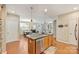 Open concept kitchen with stainless steel appliances, granite counters, and an eat-in dining area at 1405 Ridge Haven Rd, Waxhaw, NC 28173