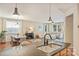 Open layout shows kitchen with granite counters and island overlooking living and dining areas at 1405 Ridge Haven Rd, Waxhaw, NC 28173