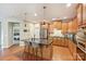 Well-lit kitchen features granite counters, stainless steel appliances and island with bar seating at 1405 Ridge Haven Rd, Waxhaw, NC 28173