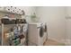 Bright laundry room with shelving, organized supplies, washer, and dryer at 1405 Ridge Haven Rd, Waxhaw, NC 28173