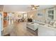 Open-concept living room flowing into dining area with hardwood floors, neutral tones, and lots of natural light at 1405 Ridge Haven Rd, Waxhaw, NC 28173