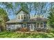 Rear exterior view of the house showcases a patio with dining and seating options and a grill at 1405 Ridge Haven Rd, Waxhaw, NC 28173