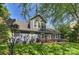 Rear exterior of the blue home with a well-manicured lawn and a patio with a dining and seating area at 1405 Ridge Haven Rd, Waxhaw, NC 28173