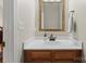 Clean bathroom featuring wood cabinets, white countertops and decorative gold framed mirror with recessed lighting at 15744 Berryfield St, Huntersville, NC 28078