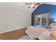 Vaulted ceiling Primary bedroom with blue accent wall and ceiling fan and plush bedding offers a bright, airy, comfortable space at 15744 Berryfield St, Huntersville, NC 28078