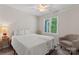 Inviting carpeted bedroom with a full bed, ceiling fan, sitting chair and plenty of natural light creates a cozy retreat at 15744 Berryfield St, Huntersville, NC 28078
