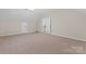 Large bonus room featuring plush carpeting, and ample space is perfect for recreation, hobbies, or additional living space at 15744 Berryfield St, Huntersville, NC 28078