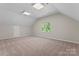 Spacious carpeted bonus room with natural light and neutral walls is ideal for entertainment or flexible living space at 15744 Berryfield St, Huntersville, NC 28078