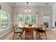Bright dining room featuring a wooden table, large windows, and natural light, perfect for Gathering dinners at 15744 Berryfield St, Huntersville, NC 28078