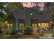 Back exterior view of home showing roof, windows, and outdoor seating area at 15744 Berryfield St, Huntersville, NC 28078