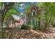 Charming two-story brick and gray home with mature trees and landscaping creating a serene and inviting atmosphere at 15744 Berryfield St, Huntersville, NC 28078