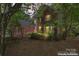 Beautiful two-story brick and gray home with decorative windows, surrounded by lush trees in a serene setting at 15744 Berryfield St, Huntersville, NC 28078