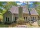 Back exterior view of home showing roof, windows, and outdoor seating area at 15744 Berryfield St, Huntersville, NC 28078