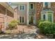 Inviting front entrance with brick and gray facade, beautiful door, and well-manicured landscaping enhancing curb appeal at 15744 Berryfield St, Huntersville, NC 28078