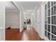 Bright hallway with hardwood floors, white trim, and transom window, leading to other rooms in the home at 15744 Berryfield St, Huntersville, NC 28078