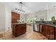Open kitchen and breakfast nook with stainless steel appliances, tile floors, and natural light, perfect for families at 15744 Berryfield St, Huntersville, NC 28078