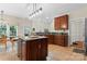 Well-lit kitchen with granite countertops, cherry cabinets, stainless steel appliances and kitchen island at 15744 Berryfield St, Huntersville, NC 28078