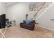 Open living room with staircase featuring tile flooring and natural light, perfect for relaxing and entertaining at 15744 Berryfield St, Huntersville, NC 28078