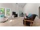 Well-lit living room with fireplace, large windows and office space, perfect for relaxing or working from home at 15744 Berryfield St, Huntersville, NC 28078