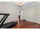 Bright living room with hardwood floors, chandelier lighting, and an open doorway, providing great space for relaxation at 15744 Berryfield St, Huntersville, NC 28078