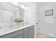 Bright bathroom featuring double vanity, white countertops, and a glass-enclosed shower at 2129 Tom Sadler Rd # 7160, Charlotte, NC 28214