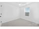 Minimalist bedroom featuring neutral carpet, a single window and simple design, offering a serene space at 2129 Tom Sadler Rd # 7160, Charlotte, NC 28214