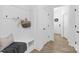 Inviting entryway with coat hooks, bench seating, and front door with wreath visible at 2129 Tom Sadler Rd # 7160, Charlotte, NC 28214
