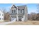 Exterior shot of a gray two-story home with a front-facing garage and inviting entrance at 2129 Tom Sadler Rd # 7160, Charlotte, NC 28214