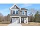 Charming two-story home with gray siding, attached garage, and inviting front porch at 2129 Tom Sadler Rd # 7160, Charlotte, NC 28214