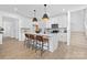 Bright kitchen featuring a large island with seating, modern pendant lights, and an open layout to the staircase at 2129 Tom Sadler Rd # 7160, Charlotte, NC 28214