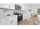 Modern kitchen featuring stainless steel appliances, white cabinets, and light gray backsplash at 2129 Tom Sadler Rd # 7160, Charlotte, NC 28214
