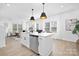 Bright, open-concept kitchen with a large island, stainless steel appliances, and modern pendant lighting at 2129 Tom Sadler Rd # 7160, Charlotte, NC 28214