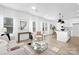 Open concept living room flowing into kitchen, featuring modern furniture, and lots of natural light at 2129 Tom Sadler Rd # 7160, Charlotte, NC 28214