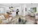 Open concept living room with kitchen in background; features modern decor, bar stool seating, and lots of natural light at 2129 Tom Sadler Rd # 7160, Charlotte, NC 28214