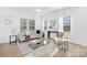 Bright living room featuring modern furniture, neutral decor, large windows, and lots of natural light at 2129 Tom Sadler Rd # 7160, Charlotte, NC 28214