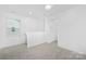 Bright loft featuring neutral decor, a window, and access to another room at 2129 Tom Sadler Rd # 7160, Charlotte, NC 28214