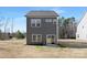 Backyard of a two-story home featuring a sliding glass door with a concrete patio at 2129 Tom Sadler Rd # 7160, Charlotte, NC 28214