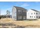 Backyard view of a modern gray two-story home with a sliding glass door to patio at 2129 Tom Sadler Rd # 7160, Charlotte, NC 28214