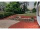 This backyard features a stone-fire pit and multiple levels of manicured landscaping at 2138 Revolution Park Dr, Charlotte, NC 28208