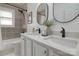 Well-lit bathroom features dual sinks, a bathtub with tile surround, and modern fixtures at 2138 Revolution Park Dr, Charlotte, NC 28208