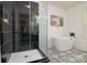Modern bathroom featuring a glass-enclosed shower, standalone tub, and decorative tile flooring at 2138 Revolution Park Dr, Charlotte, NC 28208